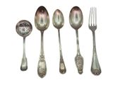 five spoons and a fork sitting next to each other