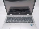 a laptop computer that is open on a white surface