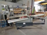 a machine that is cutting a piece of wood in a workshop