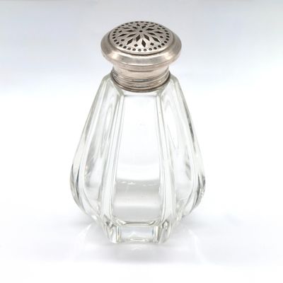 a glass salt and pepper shaker on a white surface