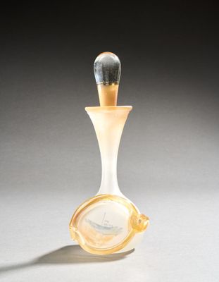 perfume bottle in the shape of a sailboat with a glass stopper