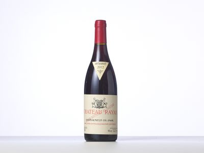 a bottle of red wine sitting on top of a table