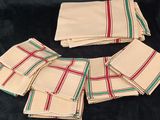 six napkins with red and green stripes on them on a black background