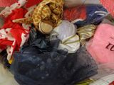 a pile of clothes and a stuffed giraffe in a bag
