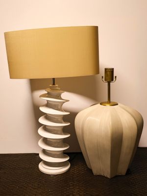a lamp that is next to a vase on a table