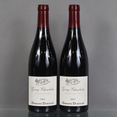 two bottles of wine sitting on a glass table