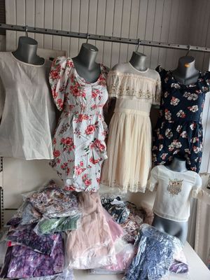 a lot of dresses on display on a table