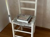a white chair with a book on top of it