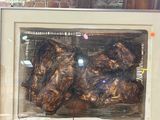 a picture of a picture of some meat in a glass case