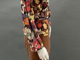 an image of a mannequin wearing a brown skirt and floral blouse