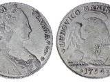 a close up of two silver coins on a white background