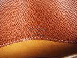 the inside of a brown purse with a brown handle