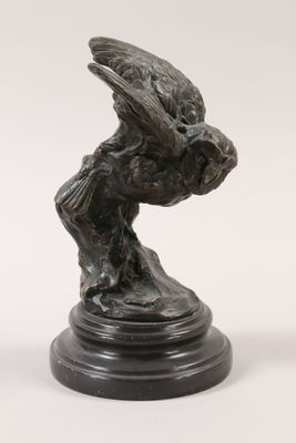 an image of a bronze statue of a bird on a pedestal