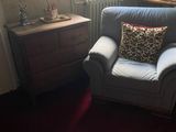 a chair that is in a room with a red carpet
