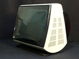an old computer monitor sitting on top of a black table