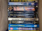 many books in a box that are stacked on top of each other