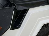 a close up of a black and white vehicle with its door open