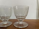 two empty wine glasses sitting on a wooden table