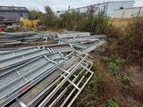 a pile of metal pipes sitting on the side of the road