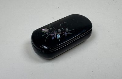 a black case with flowers on it sitting on a table