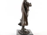 bronze statue of a man holding a baby on a marble base