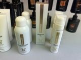 many different types of skin care products displayed on a table