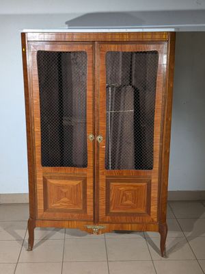 a wooden cabinet with a glass door on top of it
