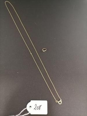 a gold necklace with a white tag on it