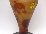 a glass vase with a brown and yellow design on it