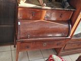 une commode en bois surmontée d'un miroir