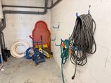 a room with a lot of hoses and other items on the floor