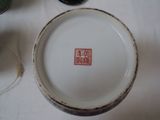 a plate with a red stamp on it sitting on a table