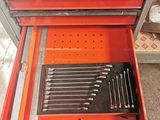 a red tool box with tools in it on the floor