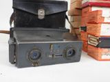 an old camera sitting on top of a stack of books