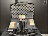 two microphones sitting in a case on a table