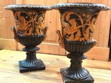 two vases sitting on a wooden table next to each other