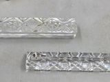 two pieces of silver that are on a table