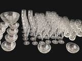 a lot of clear plastic cups and spoons on a black background