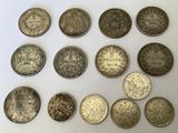 several different types of coins are shown on a white surface