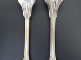 pair of silver plated forks on a black background