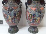 two vases that have been decorated with pictures on them