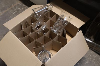 a cardboard box with a bunch of empty wine glasses in it