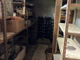 a room with shelves and boxes in it