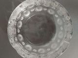 a glass bowl with a design on it sitting on a table