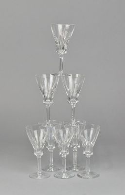 several wine glasses are stacked on top of each other on a table