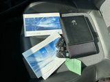 a car seat with a cell phone and a book
