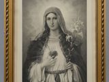 a black and white photo of a woman holding a flower