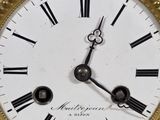 a close up of a clock with roman numerals on it