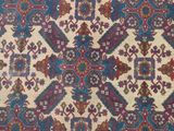 an antique persian rug with a multicolored design on a beige ground