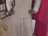 a mannequin in a clothing store with clothes on display